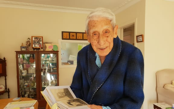 John Sato was supported by police and a helper to show his support for the Muslim community.