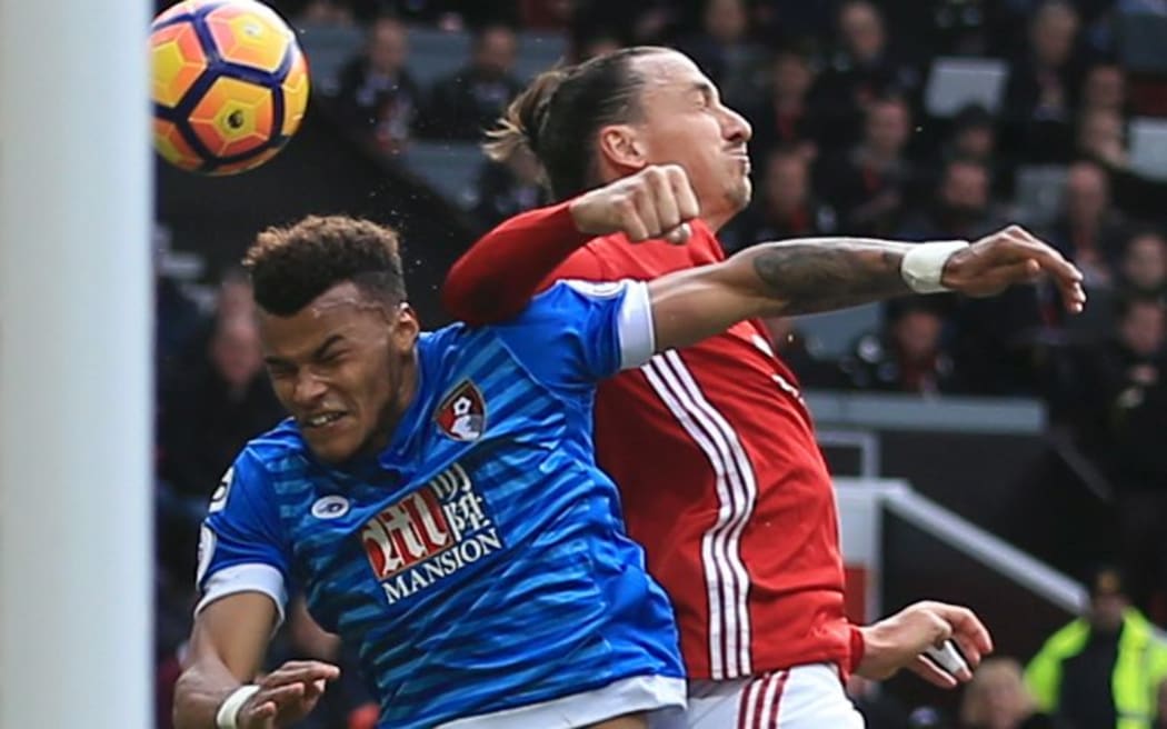 Tyrone Mings and Zlatan Ibrahimovic clash during their premier league encounter.
