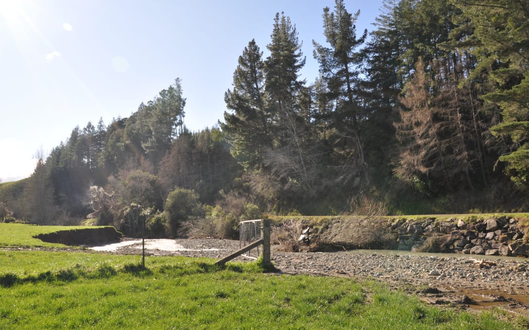The Quail Valley River has scoured out land either side of it, taking some of the road with it.