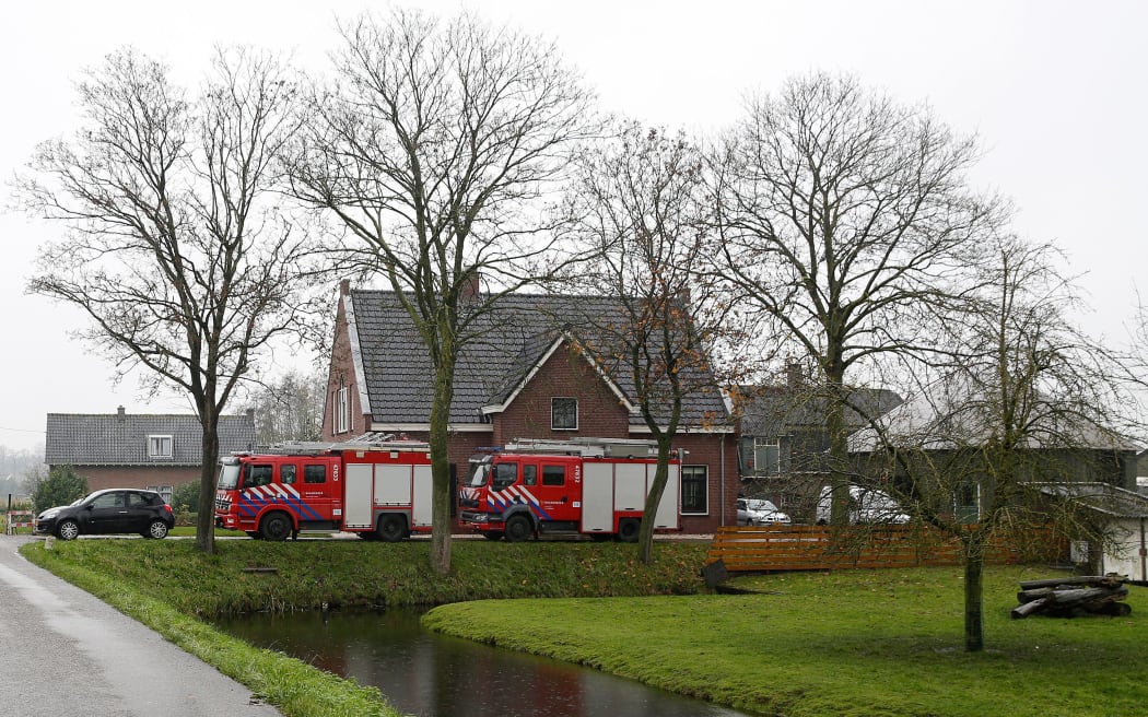 Vehicles are parked in front of the poultry farm in the village of Hekendorp, where a  strain of bird flu was found.