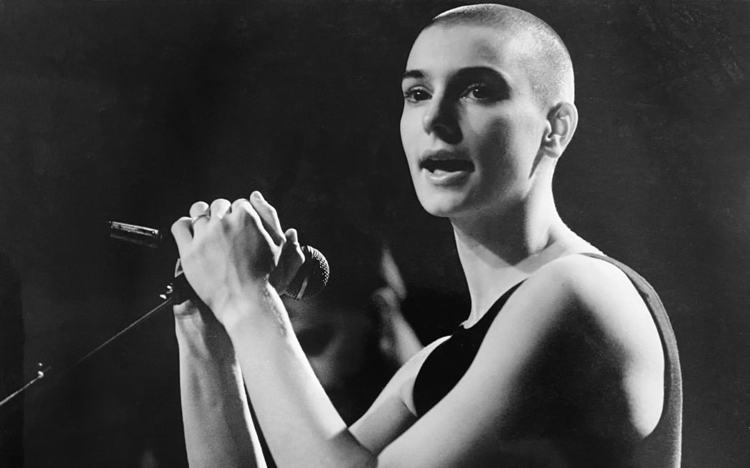 (FILES) An undated photo from the late 1980's shows Sinead O'Connor performing in Vancouver, Canada. I. rish pop singer Sinead O'Connor, who shot to worldwide fame in the 1990s, has died at the age of 56, Irish media reported on July 26, 2023. (Photo by Mandel NGAN / AFP)