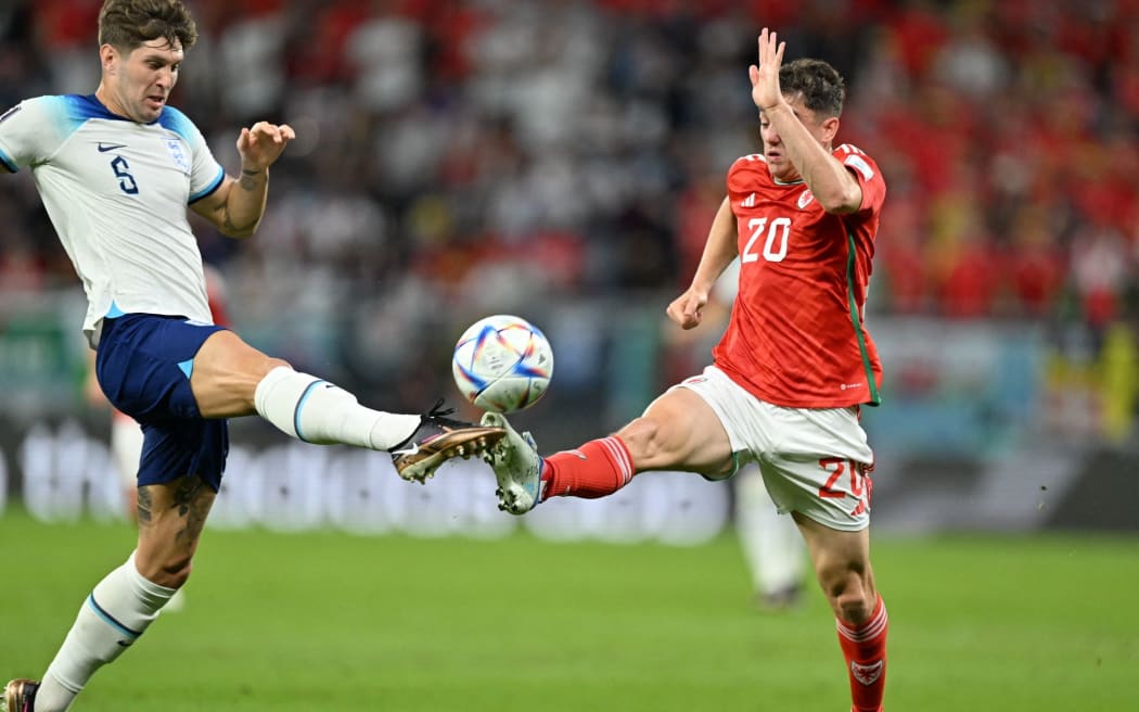 AL RAYYAN, QATAR - NOVEMBER 29: John Stones #5 of England in action against Daniel James #20 of Wales during the FIFA World Cup Qatar 2022 Group B match between Wales and England at Ahmad Bin Ali Stadium on November 29, 2022 in Al Rayyan, Qatar. Mustafa Yalcin / Anadolu Agency (Photo by MUSTAFA YALCIN / ANADOLU AGENCY / Anadolu Agency via AFP)