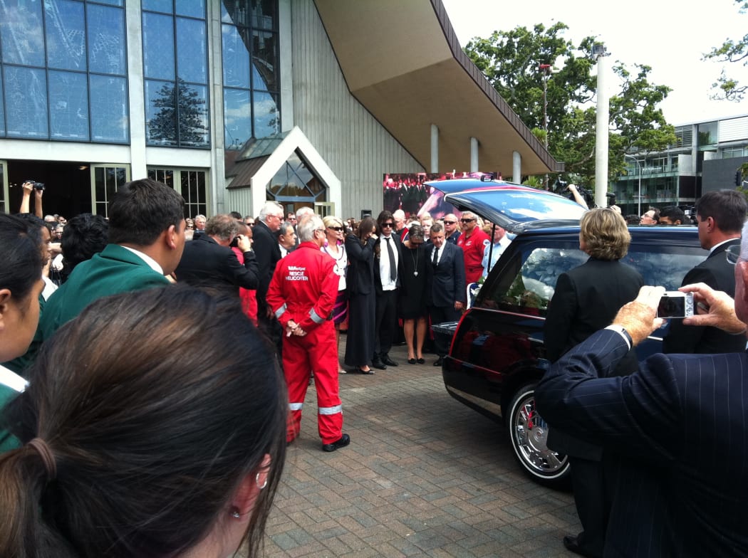 The Holmes family at the hearse before its departure.