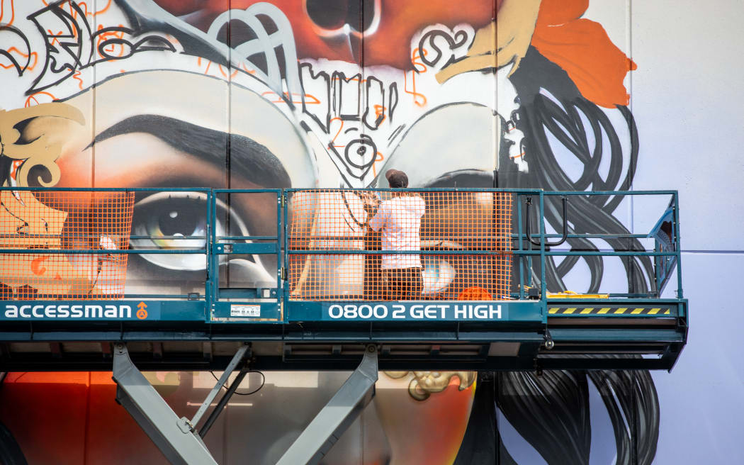 Artist Jacob Yikes (Jacob Ryan) working on New Zealand's largest mural outside the Distinction Christchurch Hotel.