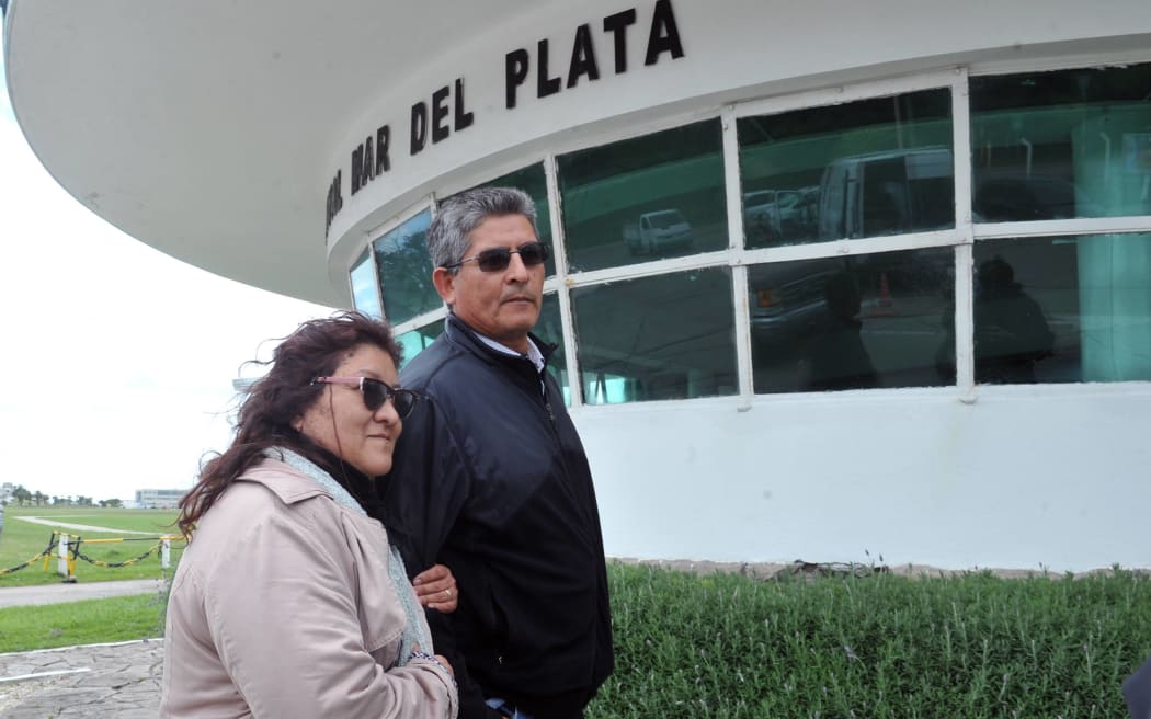 María Morales (L) mother of submarinist Luis Garcia, accompnied by an unidentified man at the entrance of Argentina's Navy base in Mar del Plata, south of Buenos Aires, on November 18, 2017.