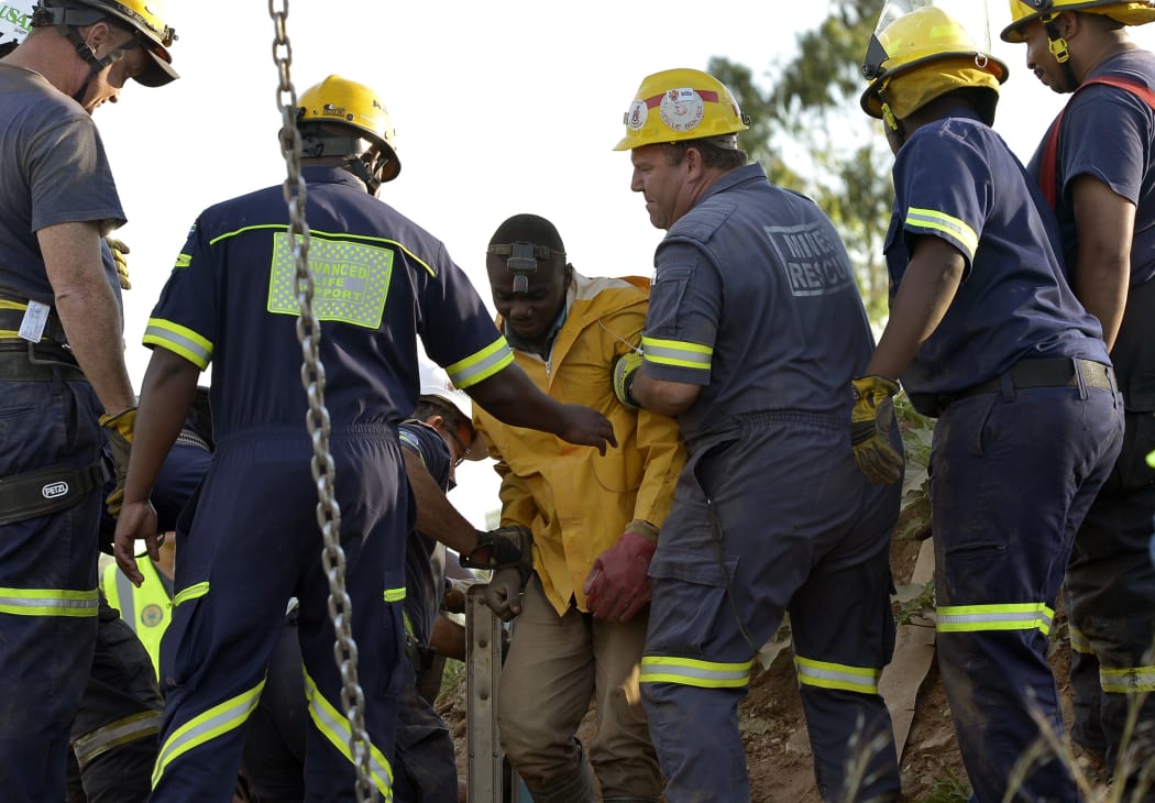 Rescuers bring one of the miners to the surface.