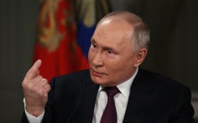 In this pool photograph distributed by Russian state agency Sputnik, Russia's President Vladimir Putin gives an interview to US talk show host Tucker Carlson at the Kremlin in Moscow on February 6, 2024. (Photo by Gavriil GRIGOROV / POOL / AFP)