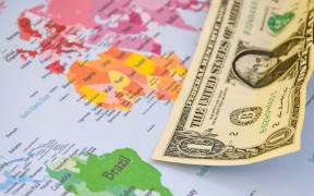 US dollar banknotes on globe world map, American investment and trading, concept of american policy and influence