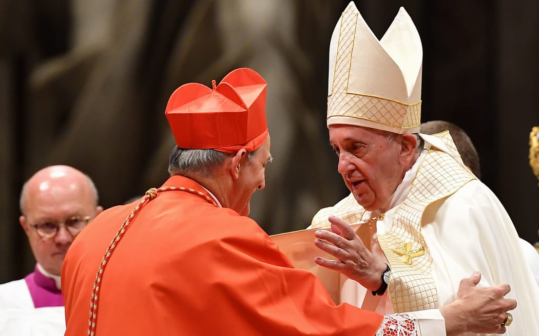 Pope Francis (R) embraces new Cardinal Italian prelate Matteo Maria Zuppi (L) after he appointed him during an Ordinary Public Consistory for the creation of new cardinals,