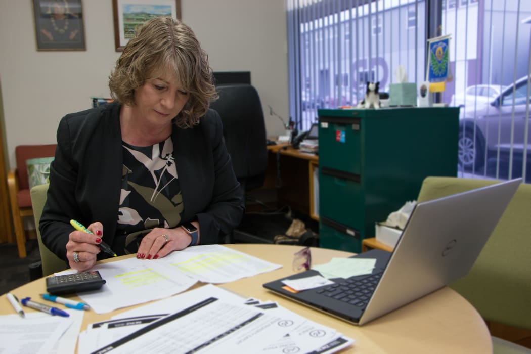 Tararua district mayor Tracey Collis pores over farm sales data in her Dannevirke office