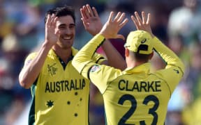Australia's paceman Mitchell Starc, left, celebrates his wicket of Pakistan's batsman Wahab Riaz.