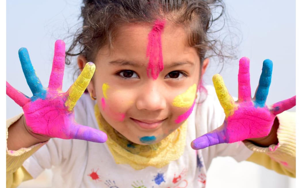little girl covered in paint