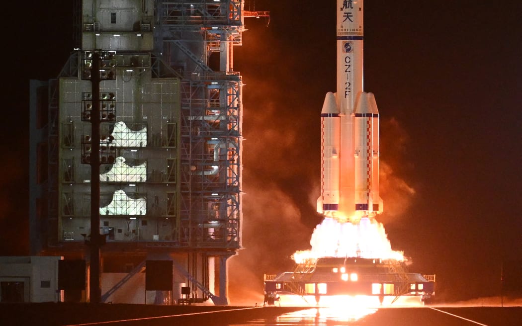 A Long March-2F carrier rocket, carrying the Shenzhou-18 spacecraft and a crew of three astronauts, lifts off from the Jiuquan Satellite Launch Centre in the Gobi desert in northwest China on 25 April, 2024.