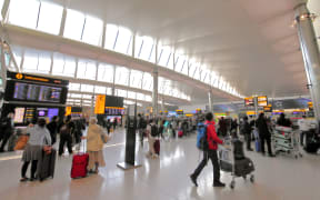 People travelling at Heathrow airport London UK in 2019.