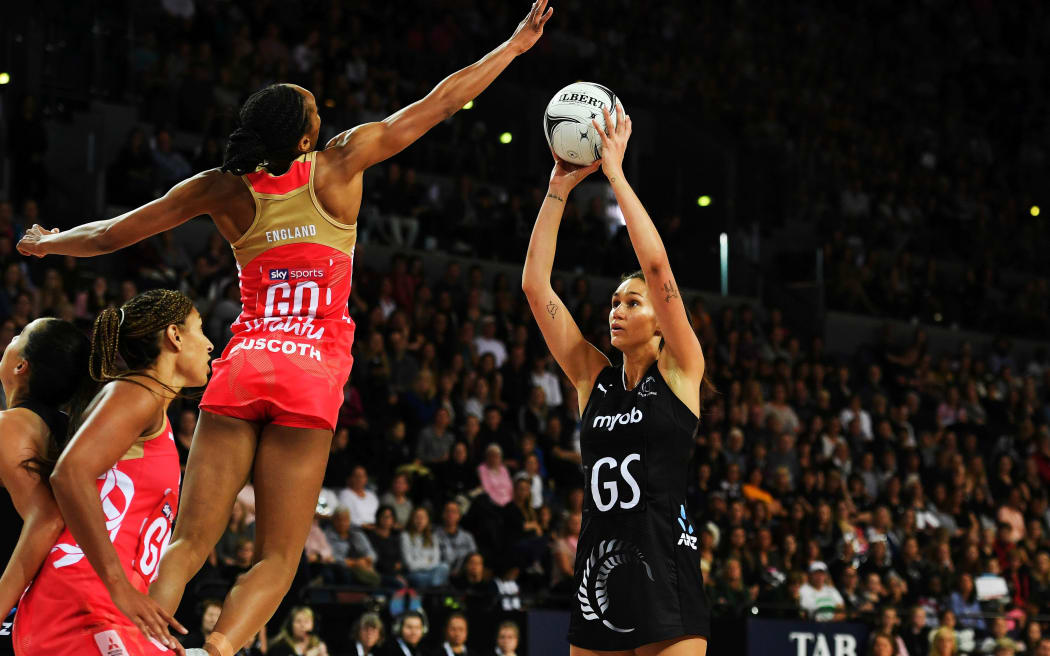 Silver Ferns Ameliaranne Ekenasio shoots for goal against the England defense.