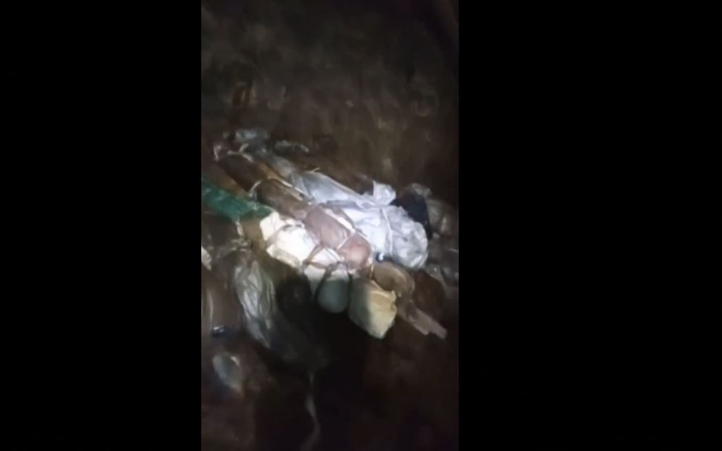 EDITORS NOTE: Graphic content / This video grab from an undated video released by Mining Affected Communities United in Action (MACUA) and Stilfontein Solidarity Committee on January 13, 2025 shows what appears to be a long line of bodies inside the mine in Stilfontein wrapped up in improvised shrouds. A long-running standoff at an abandoned mine in the South African town of Stilfontein appears to take a grim turn as footage released by two local groups working for mining communities, MACUA and Stilfontein Solidarity Committee, appeared to show a long line of bodies inside the mine wrapped up in improvised shrouds. Amongst the miners still alive several appeared from the footage to be seriously undernourished. 
Operations began on January 15, 2025 to retrieve illegal miners from an abandoned gold mine shaft in South Africa amid claims that several hundred men underground as well as many bodies.
A professional mine rescue company sent a large cage down into the shaft at Stilfontein. (Photo by MACUA and...