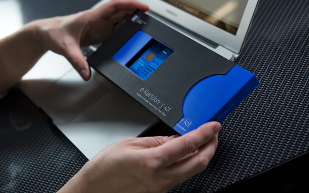Person holding Estonia's e-Residency kit; a government-issued digital identity and status that provides access to the digital business environment.