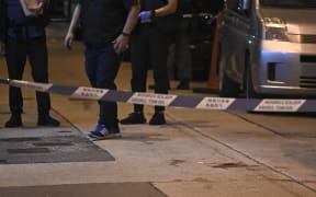 Blood is seen beyond a police cordon, where Jimmy Sham, convener of the Civil Human Rights Front (CHRF), was assaulted by four to five people wielding hammers.