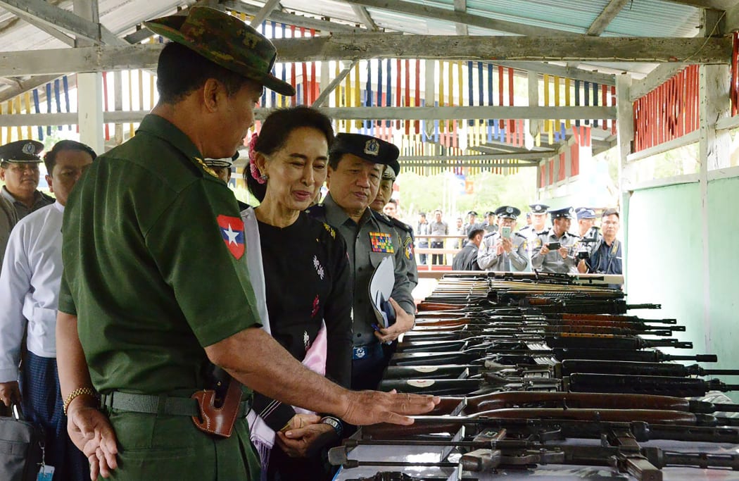 Aung San Suu Kyi accompanied by military and police officials during a visit to a police training school in Yamethin township last month.
