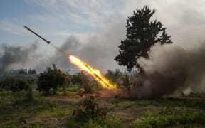 Syrian Army forces fire a missile while battling fighters linked to Syria's ousted president Bashar al-Assad in Latakia, Syria, on March 7.