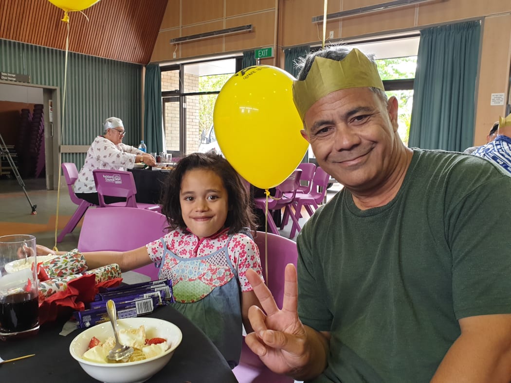 Aucklander Karl Sylva with his 5-year-old god daughter Xea enjoy City Mission's Christmas lunch at Freemans Bay, Auckland.