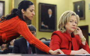 Hillary Clinton, right, receives a note from her aide Huma Abedin as she testifies during a in 2011.