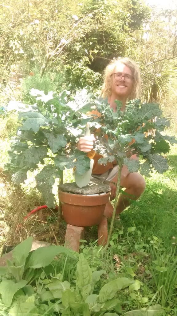 Liam Prince with his clay pot plant composting system.