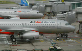 Two Jetstar Asia Airbus A320 planes are berth at the Terminal One of Singapore Changi Airport in Singapore, 13 December 2004. Jetstar Asia takes to the skies for the first time when its maiden flight to Hong Kong departs Singapore's Changi airport 13 December.