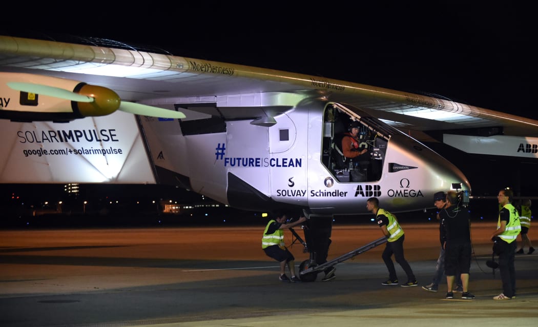 Pilot Andre Borschberg sits aboard Solar Impulse 2 prior to take-off from Nagoya's airport.
