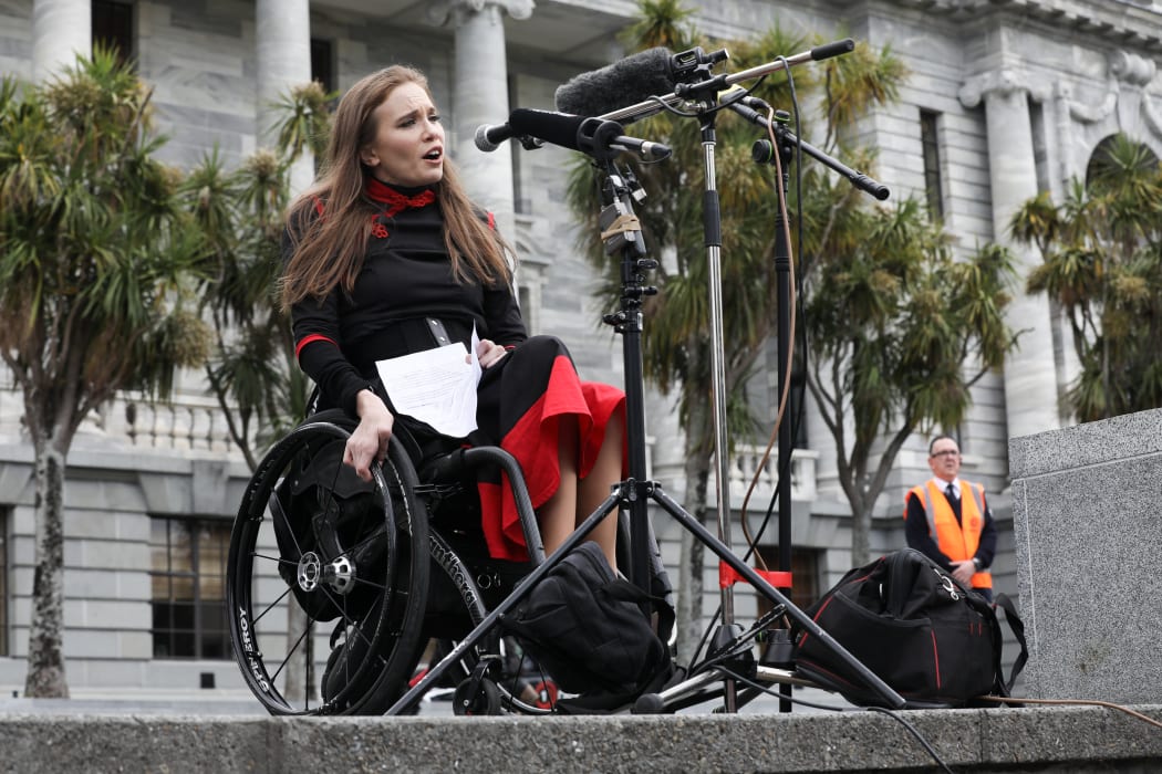 Wheelchair user Claire Freeman speaks to lunchtime protestors against the End of life Choice Bill