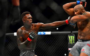 Mar 7, 2020; Las Vegas, Nevada, USA; Israel Adesanya (red gloves) fights Yoel Romero (blue gloves) during UFC 248 at T-Mobile Arena. Mandatory Credit: Stephen R. Sylvanie-USA TODAY Sports