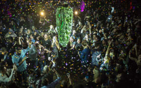 Torontonians gather at a local concert venue to watch the "bud drop" at the stroke of midnight, in celebration of the legalization of recreational cannabis.