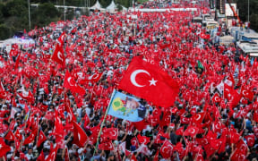 People wave Turkish national flags on July 15, 2017 during the first anniversary of failed coup in Istanbul.