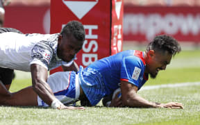 Samoa's Va'a Apelu Maliko scores a try against Fiji.