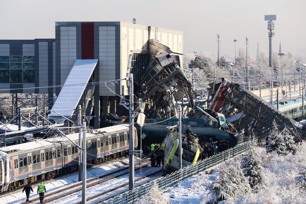 Firefighters and medics try to rescue victims after a high-speed train crashed into a locomotive in Ankara, on December 13, 2018. - Nine people were killed and nearly 50 injured in this train accident. (Photo by ADEM ALTAN / AFP)
