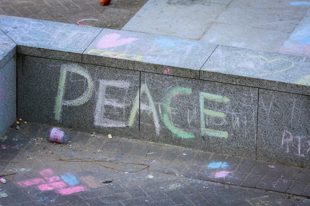 'Peace' scrawled in coloured chalk on the Parliamentary forecourt