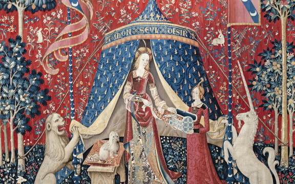 Tapestry from around 1500 of The Lady and the Unicorn Mon seul désir (La Dame à la licorne) - hanging in Musée de Cluny Paris. The tapestry shows a noble lady with the unicorn on her left and a lion on her right; she is receiving gifts from an handmaiden. The style is milles fleurs, a thousand flowers, and includes a monkey, dogs and rabbits.