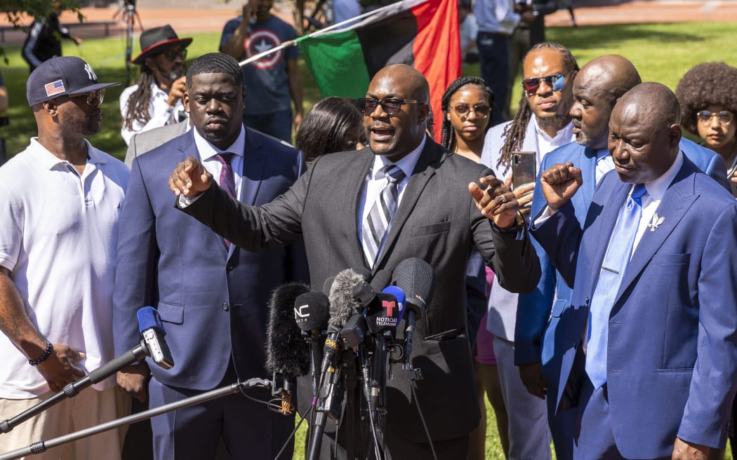 George Floyd's brothers Philonise (C) flanked by Rodney (L) and Terrence (2nd R), nephew Brandon Williams (L), and lead attorney  Benjamin Crump, and Floyd's brother Rodney Floyd (R), and Al Sharpton (2ndR),