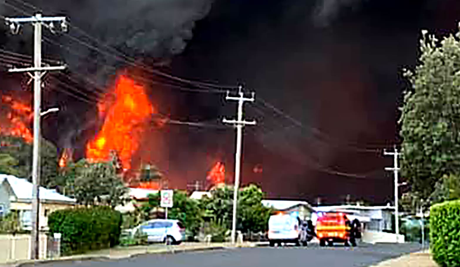 Flames from an out of control bushfire seen from a nearby residential area in Harrington, some 335 kilometers northeast of Sydney.