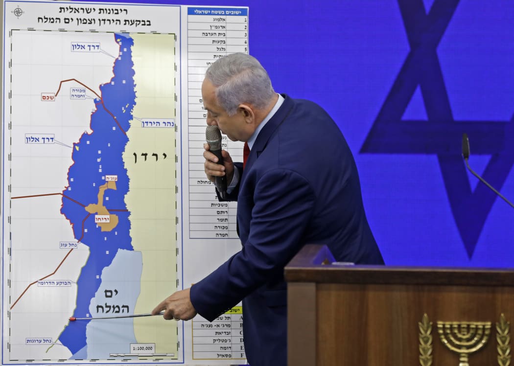 Israeli Prime Minister Benjamin Netanyahu points at a map of the Jordan Valley as he gives a statement in Ramat Gan, near the Israeli coastal city of Tel Aviv, on September 10, 2019.