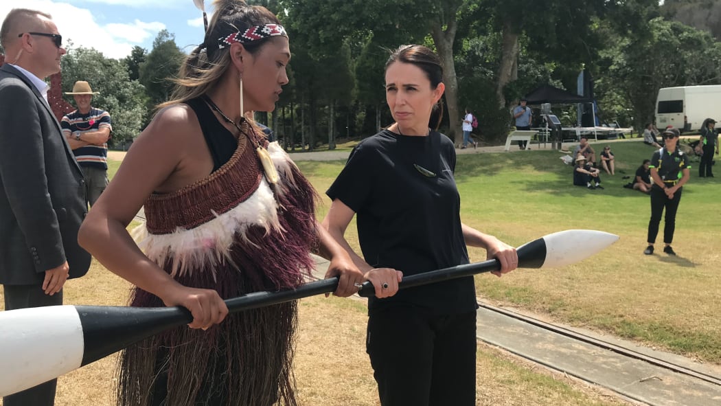 Prime Minister Jacinda Ardern takes instruction for paddling in preparation for boarding a waka hourua at Waitangi.
