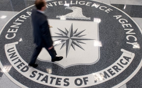 (File) A man crosses the Central Intelligence Agency (CIA) seal in the lobby of CIA Headquarters in Langley, Virginia, in 2018.