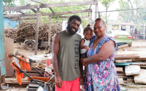 Frederica Atavi (right) with her son and husband Tom, feels the post-cyclone response has been slow.