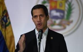 Venezuelan opposition leader and self-proclaimed acting president Juan Guaido speaks during a press conference in Caracas, on December 1, 2019.