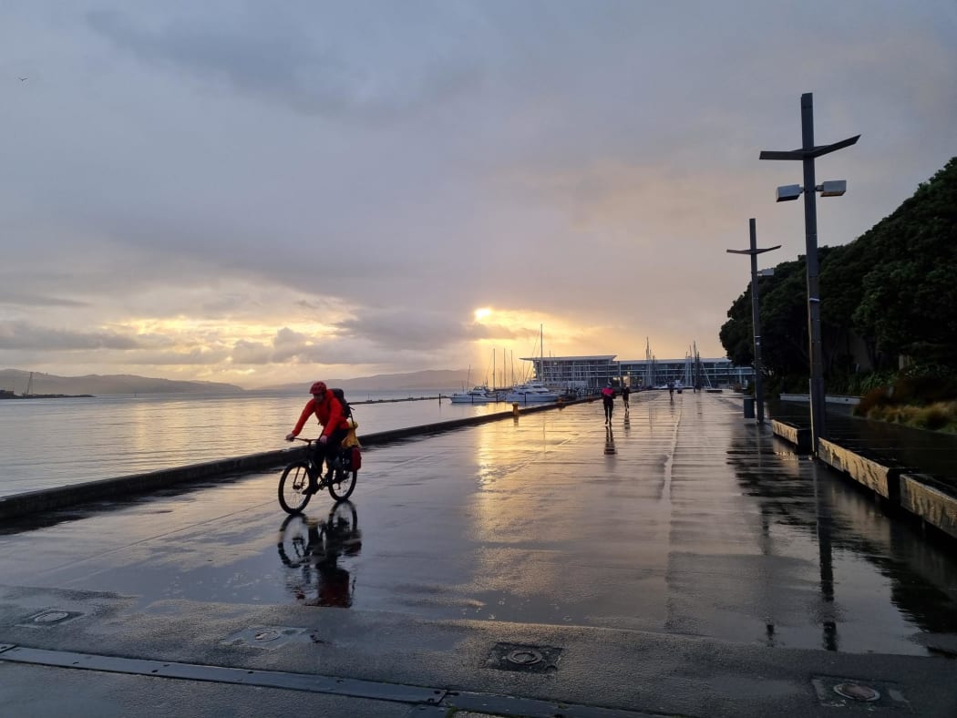 The rain has set in on the Wellington waterfront, as the sun rises and a handful of people exercise