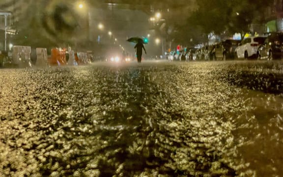 A person makes their way in rainfall from the remnants of Hurricane Ida on September 1, 2021, in the Bronx borough of New York City.