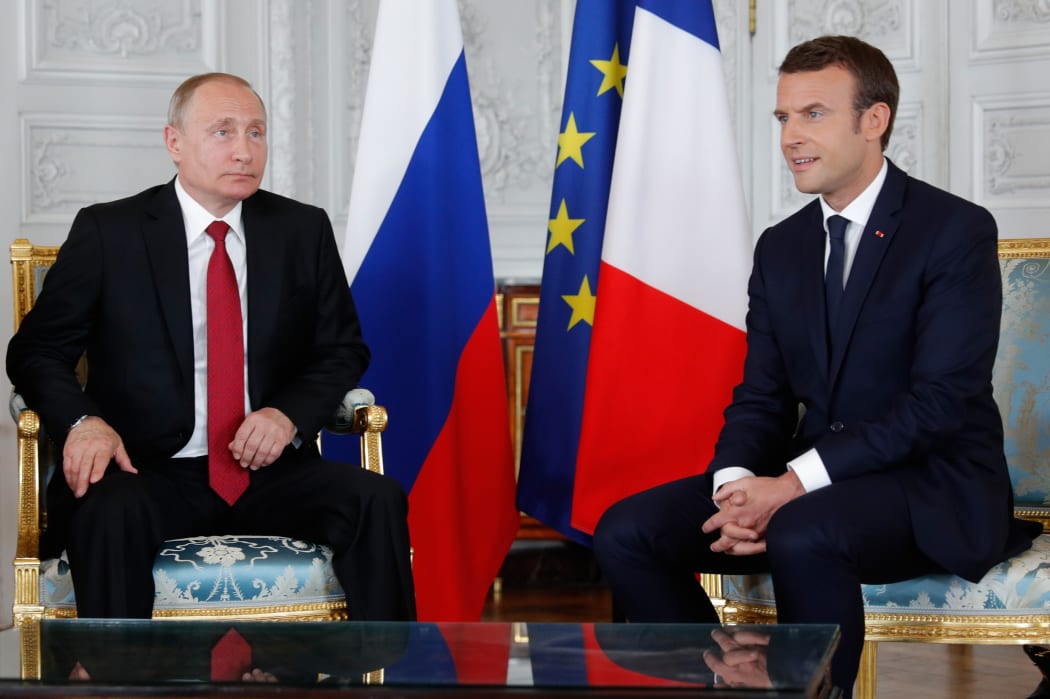 French President Emmanuel Macron (R) and Russian President Vladimir Putin (L) meet for talks at the Versailles Palace, near Paris, on May 29, 2017.