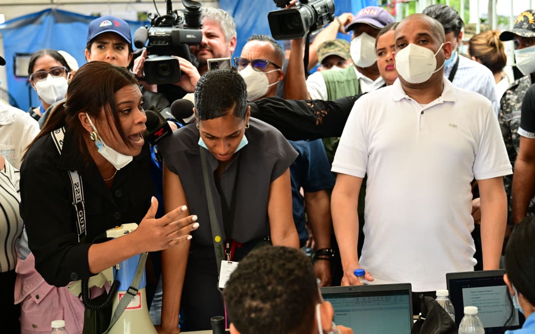 A woman argues with Forensic National Institute morgue employees for delays on information on their relatives after the Jet Set nightclub roof collapsed in Santo Domingo on April 11, 2025. Grief-stricken Dominicans began holding funerals for loved ones who were among at least 220 people killed in a nightclub rooftop collapse, even as dozens remained unaccounted for. (Photo by MARTIN BERNETTI / AFP)