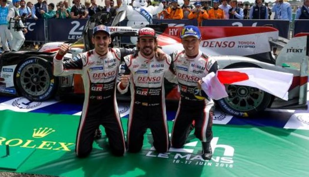 Fernando Alonso celebrates with teamates 
Sebastien Buemi and Kazuki Nakajima.