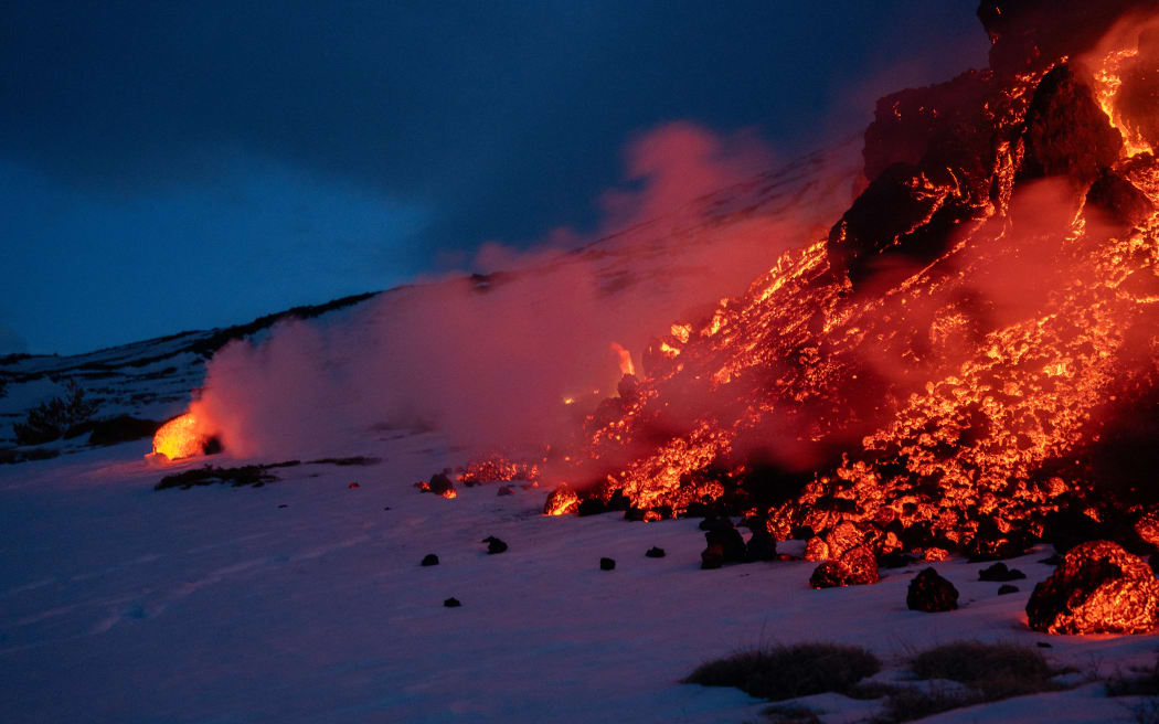 Lava flows from a fracture on the Mount Etna during an eruption of the volcano on February 14, 2025. (Photo by Etna Walk / AFP)